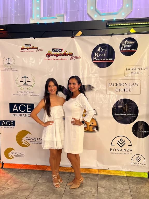 Bonanza founder Giannina Fuentes and Raiza posing in front of a sponsor backdrop with the Bonanza logo near the lower right